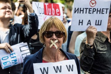 A protester with tape covering her mouth takes part in the March for Free Internet in central Moscow on July 23, 2017. Illustrative photo. (Source: Getty Images)