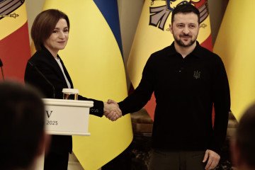 Moldovan President Maia Sandu and Ukrainian President Volodymyr Zelenskyy shake hands during a joint press conference in Kyiv, January 25, 2025. (Source: Getty Images)