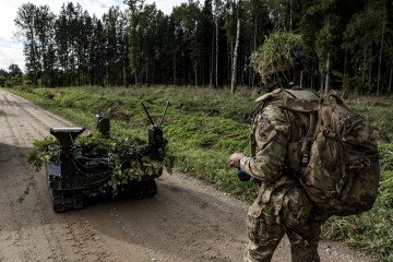 An operator of the Combat Gereon, an ARX Robotics GmbH uncrewed ground vehicle (UGV), during NATO-linked military exercises with British, Latvian, Canadian, and Italian forces, in Latvia, on October 5, 2025.