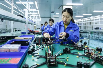Employees work on a production line of drones intended for export at a factory in Ruichang, in China’s eastern Jiangxi province, on November 27, 2024. (Source: Getty Images)
