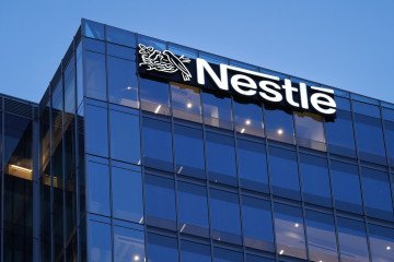 The corporate logo of the Nestlé food company is visible on top of its US headquarters building on May 16, 2025. Illustrative photo