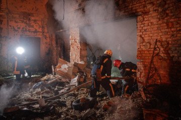 Firefighters extinguish a fire after a Russian missile attack. (Source: Getty Images)