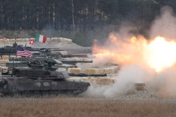 Main battle tanks from different countries, including the United States, Italy, Switzerland, and Denmark, fire a volley during the US Army Europe and Africa International Tank Challenge on February 11, 2025, at Grafenwoehr, Germany. (Source: Getty Images)