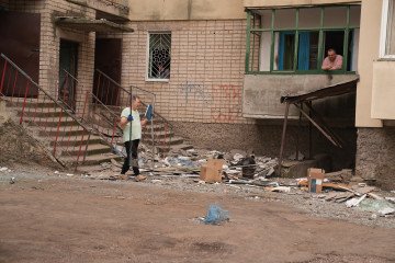 One Killed, 14 Injured in Russian Attacks Across Dnipropetrovsk and Kherson Regions People clean up after a Russian attack in Kherson. (Source: Getty Images)