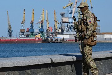 A Russian serviceman patrols on the promenade in Berdyansk, amid the ongoing Russian military action in Ukraine, on June 14, 2022. (Source: Getty Images)