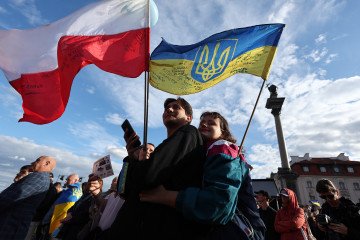 People gather to celebrate the Independence Day of Ukraine at Castle Square in Warsaw, Poland, on August 24, 2025. (Source: Getty Images)