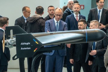 German Chancellor Friedrich Merz and Ukrainian President Volodymyr Zelenskyy look at the Anubis strike drone, April 2026. (Source: Auterion)