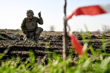 A sapper from the 808th Pontoon-Bridge Brigade searches for explosive ordnance in the deoccupied territory of the Kherson region, Ukraine, on November 22, 2025. (Source: Getty Images)