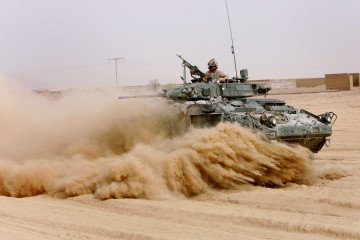 Soldiers from Charles Company, The Royal Canadian Regiment, drive their Light Armoured Vehicle (LAV) through a volatile area in Panjwayi district, Kandahar province, 9 November 2006. (Source: Getty Images)