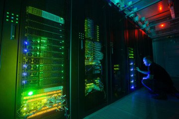 An employee inspects the Sberbank and SberCloud Christofari supercomputer during an event to mark its launch into commercial operation inside the Sberbank PJSC data processing center (DPC) in Moscow, Russia. (Source: Getty Images)