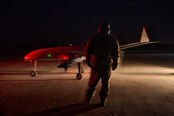 Ukrainian soldier prepares a Liutyi long-range strike drone for a night mission on the airstrip. (Source: UNITED24 Media)