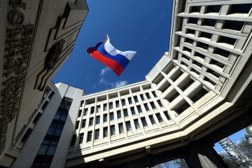 A Russian flag flies in the courtyard of the parliament building in Simferopol, Crimea, on March 18, 2014. (Source: Getty Images)