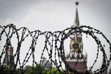 This photograph shows a view of the Kremlin taken on May 21, 2026, through the barbed wire of a municipal technical facility in Moscow. This photograph shows a view of the Kremlin taken on May 21, 2026, through the barbed wire of a municipal technical facility in Moscow.