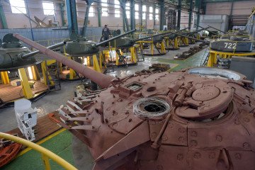 Employees of the 61st armoured military vehicles repair factory renovate and repair T-34 tanks handed over by Laos to Russia, in Strel'na outside Saint Petersburg on February 25, 2020. - Military officials plan to use the repaired tanks in Victory Day par