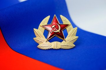 Soviet symbols against the background of the Russian flag. (Source: Getty Images)