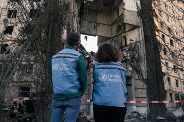 UN workers inspect a residential building damaged by an air strike in Kharkiv, Ukraine, September 24, 2024. (Source: Getty Images)