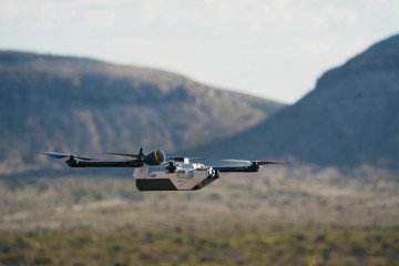 Anduril’s Bolt-M FPV drone in flight during a field test, with mountainous terrain in the background. (Photo: Anduril Industries)
