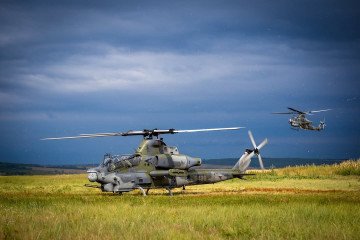 A US-made AH-1Z Viper attack helicopter operates during a field exercise under overcast skies. (Source: US DoD)