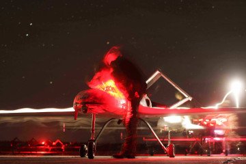 A Ukrainian servicemember prepares a long-range attack drone for a nighttime mission. A Ukrainian servicemember prepares a long-range attack drone for a nighttime mission.