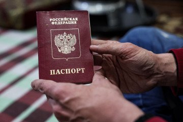 Estonia Sets New Border Crossing Requirements for Russian Diplomats and Consular Staff slam Shakhbanov, a 37-year-old fighter from Russia's Muslim-majority Dagestan republic now-turned sushi restaurant owner and manager, holds his expired Russian passport. Illustrative image. (Photo: Getty Images)