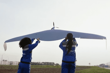 Two workers stand next to a drone airframe in a still frame from an Alabuga youth recruitment video on YouTube. Two workers stand next to a drone airframe in a still frame from an Alabuga youth recruitment video on YouTube.