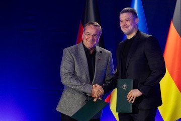 Ukraine's Defense Minister Mykhailo Fedorov shakes hands with Germany's Defense Minister Boris Pistorius after signing a letter of intent on cooperation in the field of defense technology and innovation in Kyiv on May 11, 2026. (Source: Getty Images)