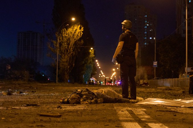 A police officer stands near the body of a victim at the site of a Russian ballistic missile strike in Kyiv. (Source: Mykyta Shandyba/UNITED24 Media) A police officer stands near the body of a victim at the site of a Russian ballistic missile strike in Kyiv. (Source: Mykyta Shandyba/UNITED24 Media)