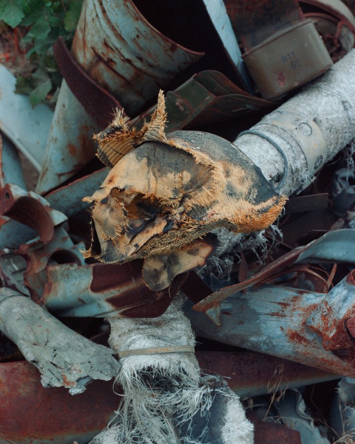 Explosive Remnants of War and a crushed Russian helmet collected by Yurii and Valerii. Dovhenke, Ukraine. October, 2025. Photo by Joshua Olley/UNITED24 Media.