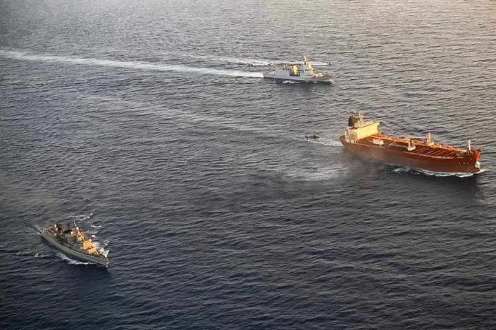 The sanctioned tanker Toa Payoh surrounded by EU naval vessels during an inspection operation in the Mediterranean Sea. (Source: Italian Defense Ministry)