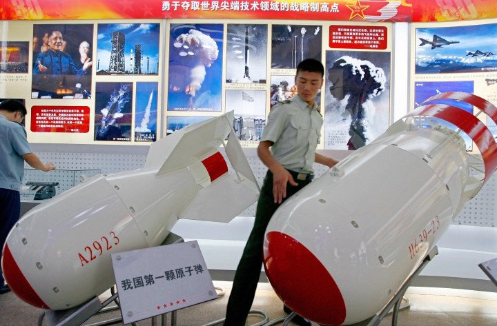 A soldier of China's People's Liberation Army between a Chinese made atomic bomb (L) and a combination hydrogen/atomic bomb (R) (Source: Teh Eng Koon via Getty Images) A soldier of China's People's Liberation Army between a Chinese made atomic bomb (L) and a combination hydrogen/atomic bomb (R) (Source: Teh Eng Koon via Getty Images)