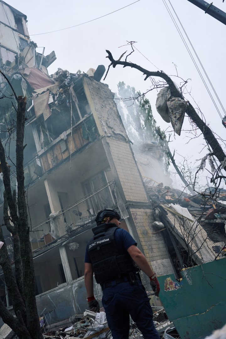 A Ukrainian rescuer surveys the ruins of a residential building leveled by a Russian missile. The impact left dozens injured and families buried beneath the rubble. Kyiv, Ukraine. July 31, 2025. Photo by Josh Olley/UNITED24 Media