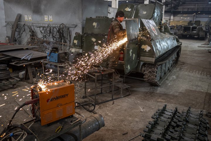 A Ukrainian mechanic modifies a captured Russian MT-LB armored vehicle for use as a medical evacuation vehicle at a refurbishment facility in eastern Ukraine, February 13, 2023. (Source: Getty Images)