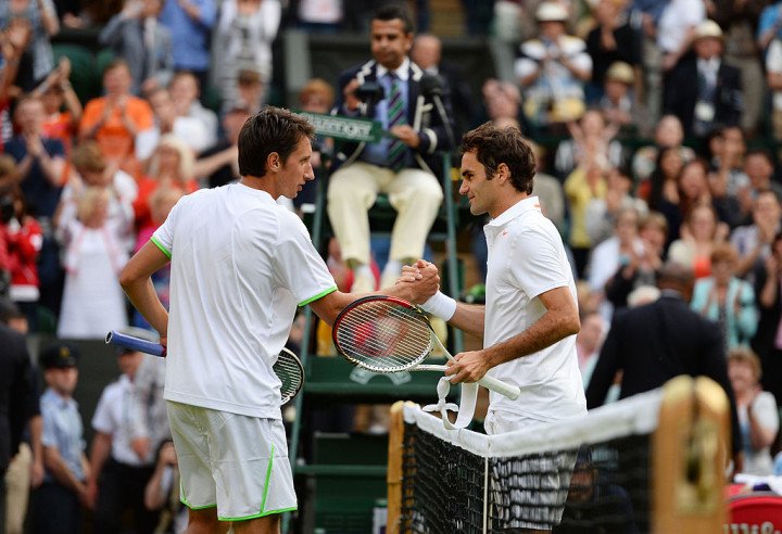 Stakhovsky shakes hands with Federer after their second round match on day three of the Wimbledon Lawn Tennis Championships, June 2013. Photo by Mike Hewitt/Getty Images.