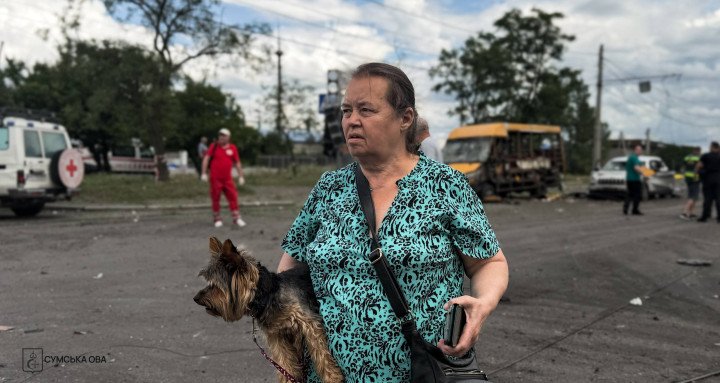 A resident stands near the site of a Russian guided bomb strike in Sumy on July 11, 2026. (Source: Sumy Regional Military Administration)
