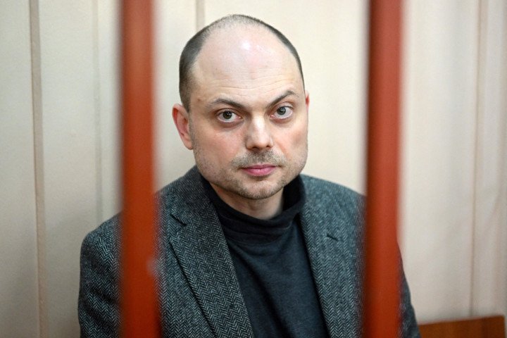 Russian opposition activist Vladimir Kara-Murza sits on a bench inside a defendants' cage during a hearing at the Basmanny court in Moscow on October 10, 2022. (Source: Getty Images)