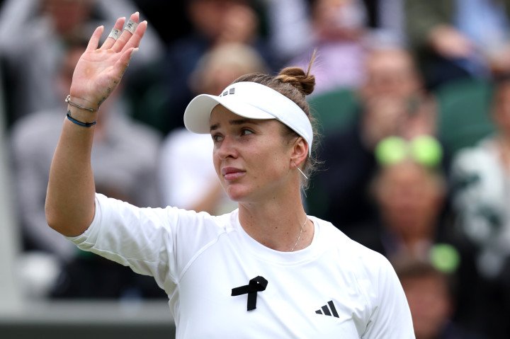 Elina Svitolina of Ukraine acknowledges the crowd as she celebrates match point while wearing a black ribbon in support of Ukraine in the Ladies' Singles fourth round match against Xinyu Wang of People's Republic of China during day eight of The Championships Wimbledon 2024 at All England Lawn Tennis and Croquet Club on July 08, 2024, in London, England. (Source: Getty Images) Elina Svitolina of Ukraine acknowledges the crowd as she celebrates match point while wearing a black ribbon in support of Ukraine in the Ladies' Singles fourth round match against Xinyu Wang of People's Republic of China during day eight of The Championships Wimbledon 2024 at All England Lawn Tennis and Croquet Club on July 08, 2024, in London, England. (Source: Getty Images)