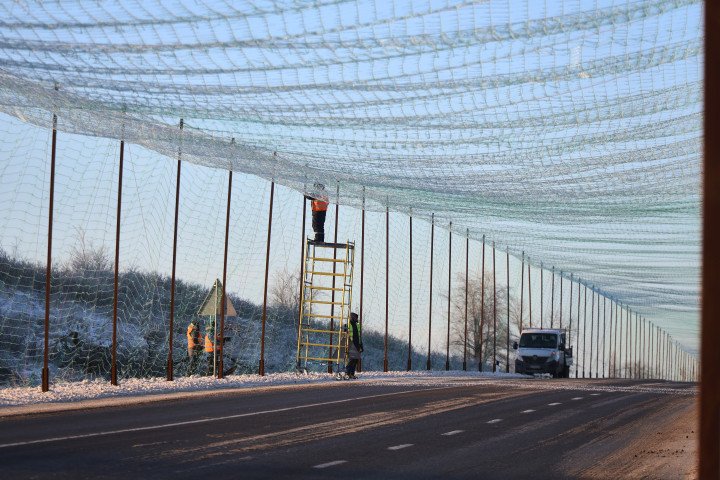 Workers install an anti-drone net over a road in the Kharkiv region, Ukraine, on February 2, 2026. (Source: Getty Images) net