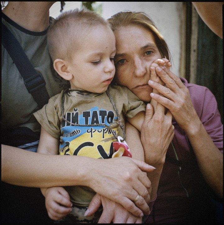 Olha Hrynyk with her nephew, Tymofii Tsvetkov, in the Poltava region. Tymofii’s T-shirt reads, “My father serves in the Armed Forces of Ukraine.” Since the full-scale Russian invasion, Olha’s husband, Mykola, has been conscripted into the Ukrainian army, along with all the men in their extended family. 2024. (Image: Anastasia Taylor-Lind) Olha Hrynyk with her nephew, Tymofii Tsvetkov, in the Poltava region. Tymofii’s T-shirt reads, “My father serves in the Armed Forces of Ukraine.” Since the full-scale Russian invasion, Olha’s husband, Mykola, has been conscripted into the Ukrainian army, along with all the men in their extended family. 2024. (Image: Anastasia Taylor-Lind)
