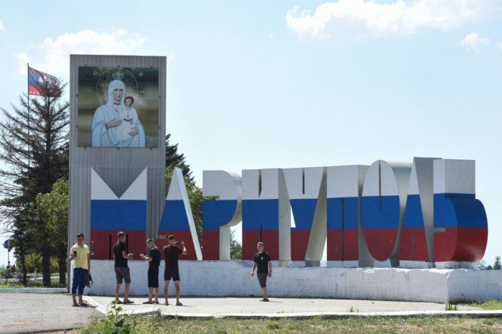 People pose for a photo in front of a sign reading as 'Mariupol' painted in the colors of the Russian flag, in Mariupol on August 16, 2023, amid the Russian invasion of Ukraine. (Source: Getty Images) People pose for a photo in front of a sign reading as 'Mariupol' painted in the colors of the Russian flag, in Mariupol on August 16, 2023, amid the Russian invasion of Ukraine. (Source: Getty Images)