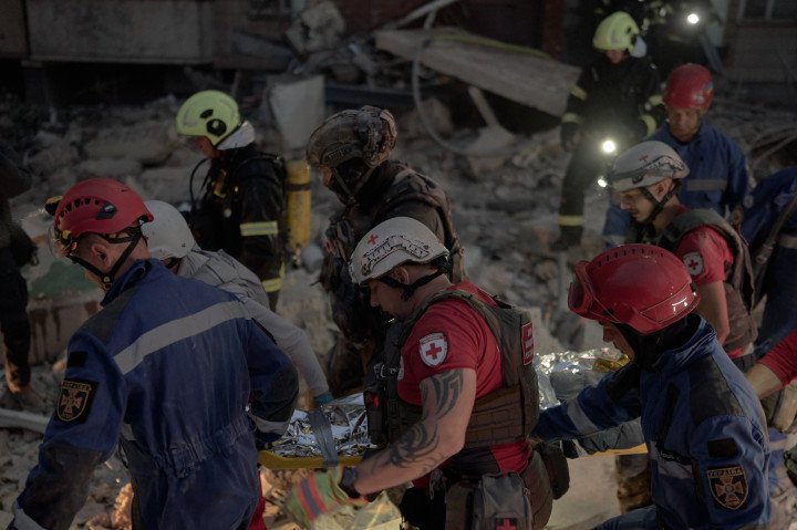 Rescuers work at a nine-story residential building in Kyiv's Podilskyi district after a Russian missile strike destroyed floors from the fifth to the ninth, on July 6, 2026 in Kyiv, Ukraine. (Photo by Kostiantyn Liberov/Libkos/Getty Images) Russia Pounds Kyiv With Ballistic Missiles