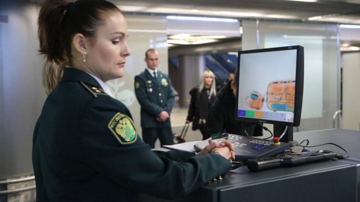 A Russian customs officer monitors baggage screening at an airport checkpoint. A Russian customs officer monitors baggage screening at an airport checkpoint.