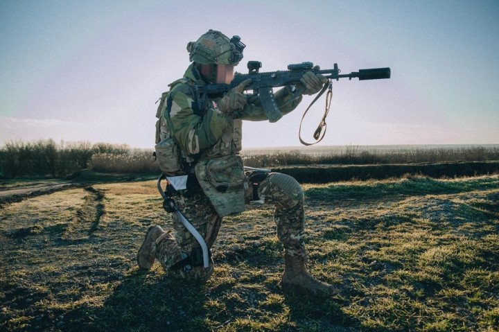 A Ukrainian soldier wearing a combat exoskeleton takes a firing position during field trials. (Source: RDK) A Ukrainian soldier wearing a combat exoskeleton takes a firing position during field trials. (Source: RDK)