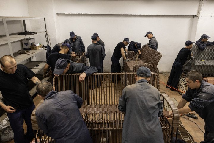 Russian POWs are seen working in a furniture workshop in the prisoner of war detention camp on August 3, 2023 in the Lviv region, Ukraine. Hundreds of captured Russian POWs including conscripts, mercenaries, Wagner militia and Storm-Z Russian prisoners are being held in up to 50 sites around Ukraine. Storm-Z is a series of penal military units established by Russia since April 2023. (Photo by Paula Bronstein /Getty Images)