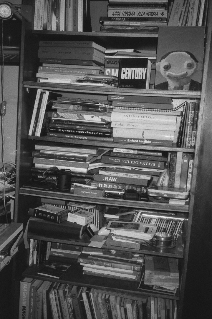 Photographer Oleksandr Glyadelov’s bookshelf, in his appartement in Kyiv. Kyiv, Ukraine, September 2025. Photo: Josh Olley/UNITED24 Media