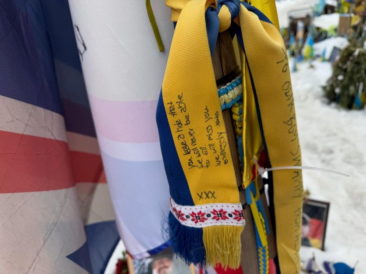 A British flag and a commemorative tribute ribbon placed among thousands of small Ukrainian flags at a temporary war memorial for fallen soldiers on Independence Square (Maidan) in Kyiv.