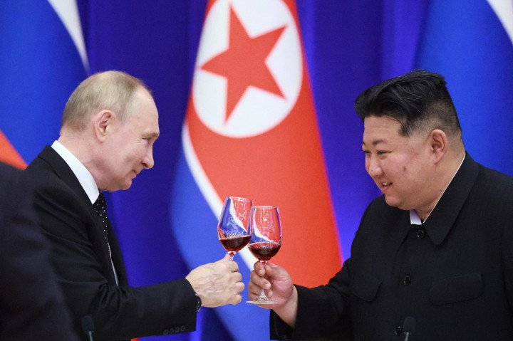 In this image, Russian leader Vladimir Putin and North Korean leader Kim Jong-un celebrate after signing a mutual defense pact between their two countries. (Source: KCNA) In this image, Russian leader Vladimir Putin and North Korean leader Kim Jong-un celebrate after signing a mutual defense pact between their two countries. (Source: KCNA)