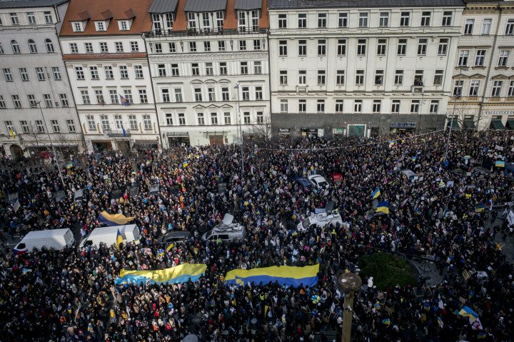 People hold Ukrainian flag as they demonstrate for peace in Ukraine in Prague, Czech Republic. (Photo by MICHAL CIZEK/AFP via Getty Images)