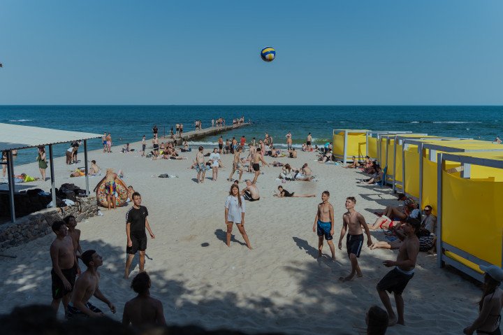 People relax on a beach in Odesa, near the Black Sea. Almost every day, the Russian army attacks Odesa with drones and missiles, destroying buildings, infrastructure, and killing civilians. (Photo by Valentyna Polishchuk/Global Images Ukraine via Getty Images)