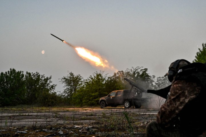 A serviceman of the Steppe Wolves volunteer unit stands near a pickup truck fitted with captured Grad rocket launch tubes during a combat mission in the Zaporizhzhia region, April 27, 2024. (Source: Getty Images)