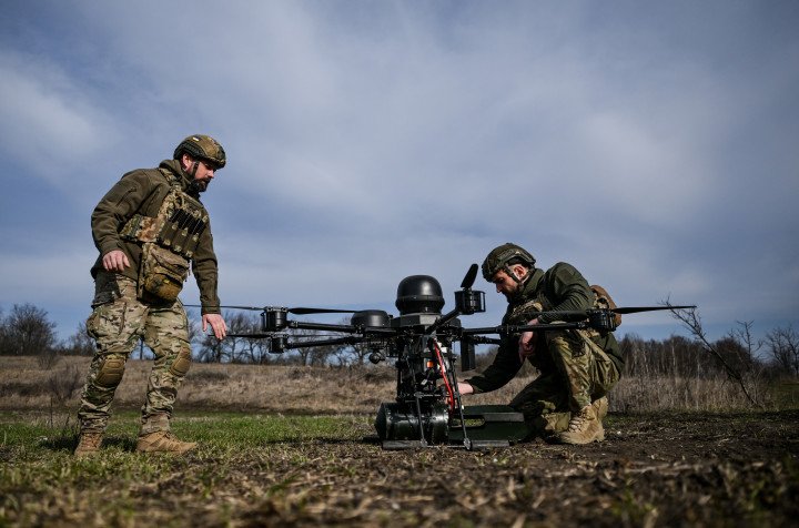 Soldiers from a drone unit of a battalion of Ukraine's 422nd Separate Unmanned Systems Regiment prepare a Baba Yaga heavy bomber drone before a daytime training flight (Photo by Dmytro Smolienko via Getty Images)